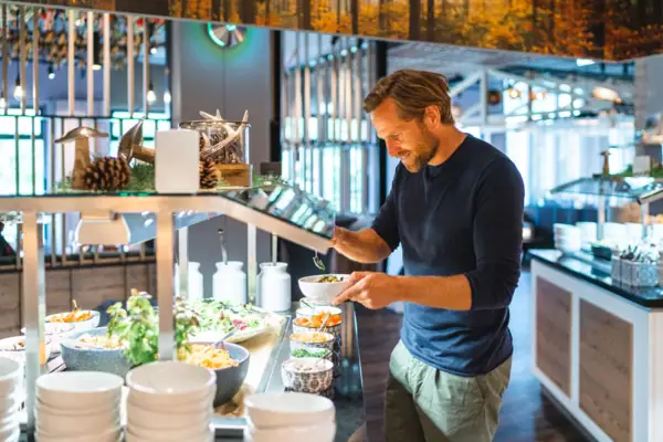 A man is standing in a restaurant.