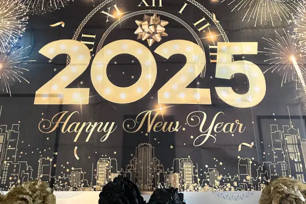 Large banner with numbers and fireworks in the background.