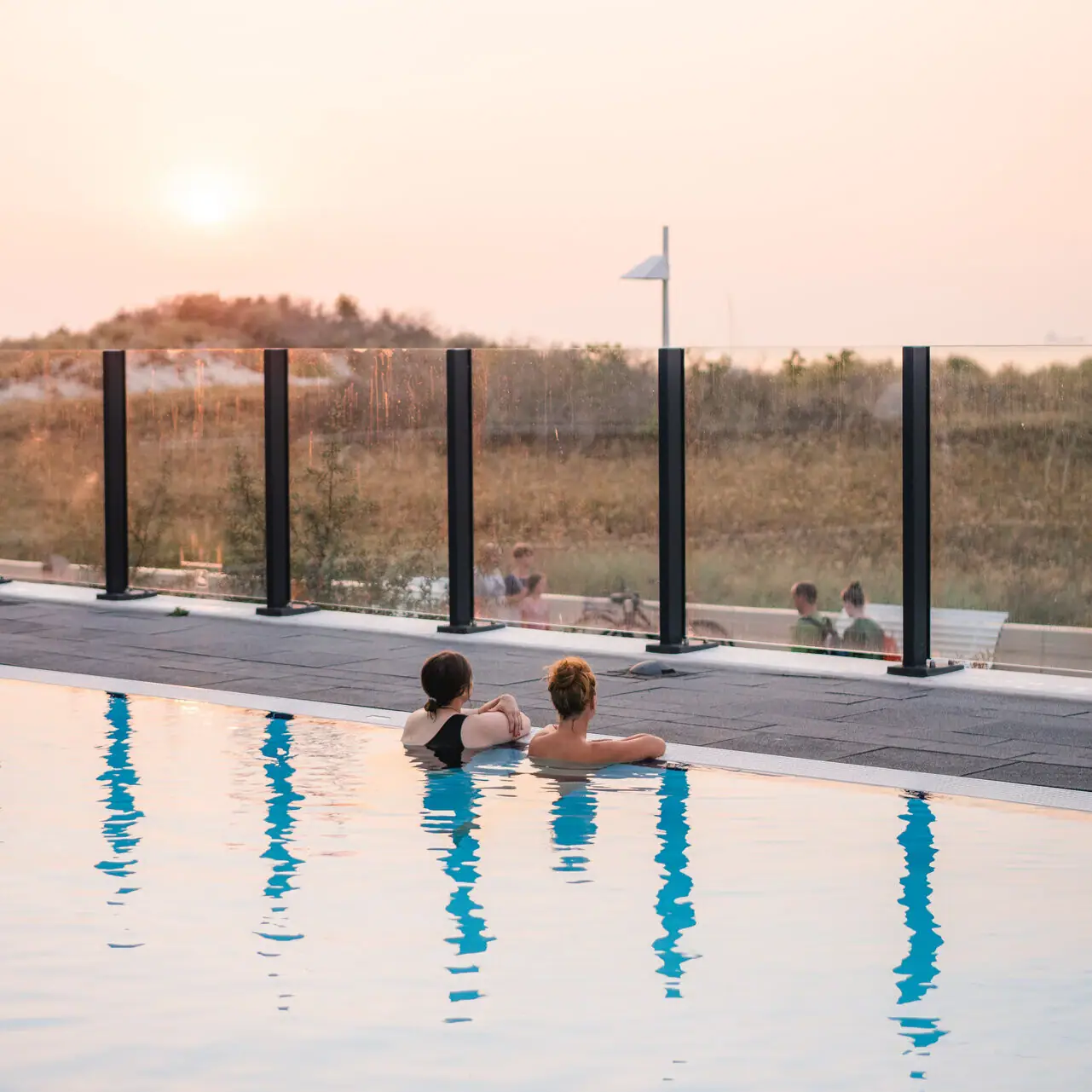 Outdoor pool aja Warnemünde Two people swimming in the pool.
