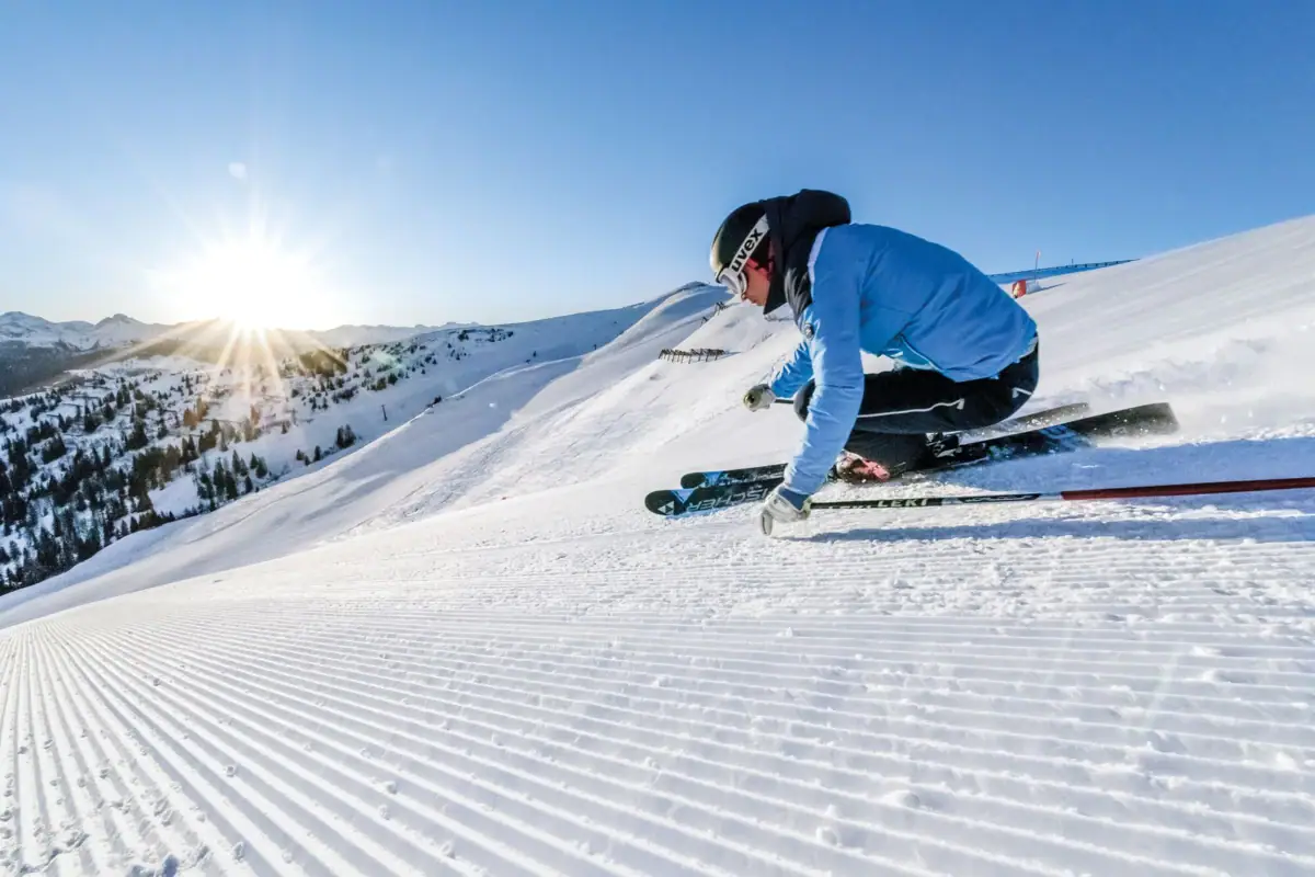 Person skiing on a snow-covered piste.