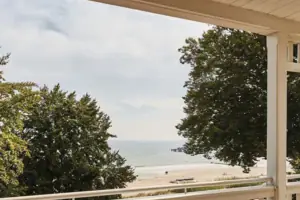 A terrace with chairs and a table on it.