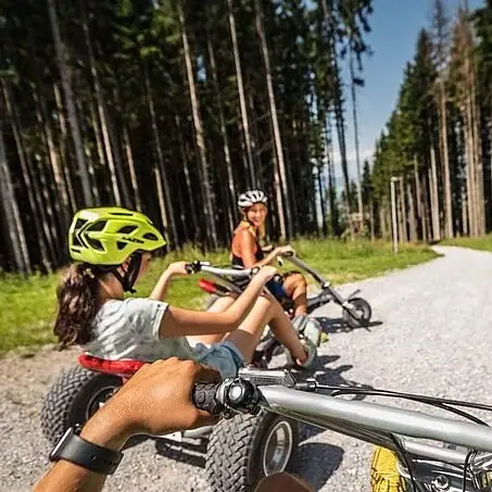 A group of people riding bicycles on a country lane.