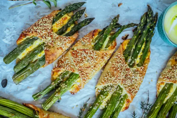 A group of asparagus wrapped in puff pastry.