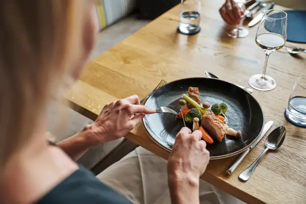 One person eats from a plate.