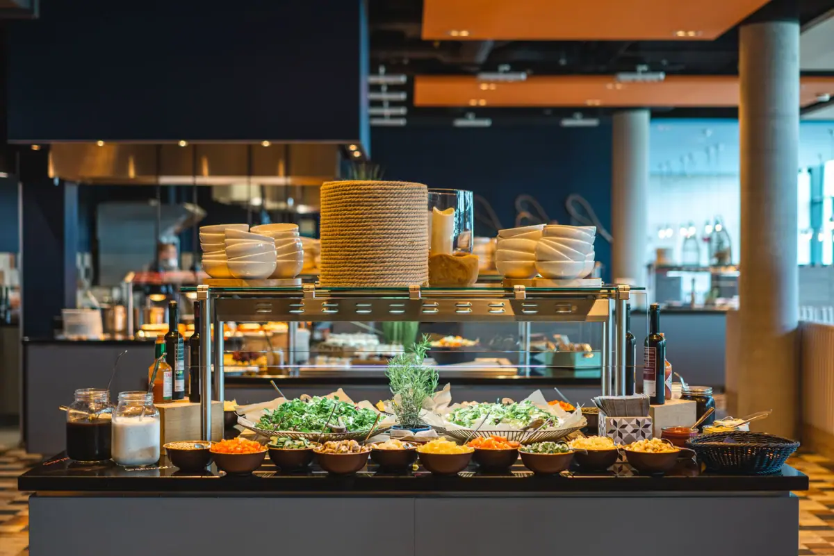 A buffet table with a variety of dishes.