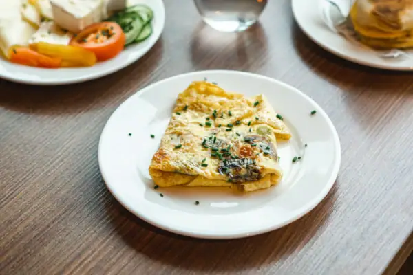 A table with plates full of food and drinks.