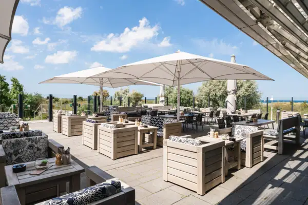 Terrace at aja Warnemünde A terrace with tables and chairs.