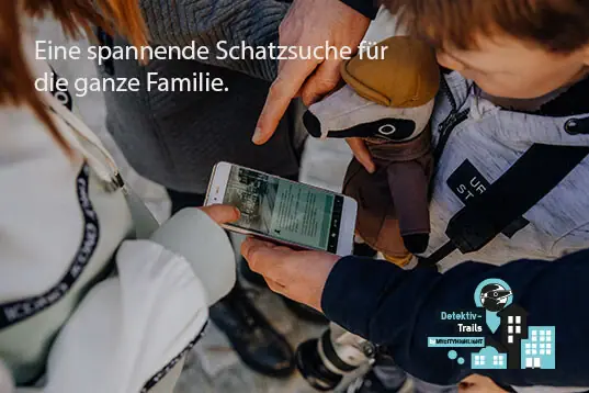 A person is holding a mobile phone, whilst a child is holding some soft toys.