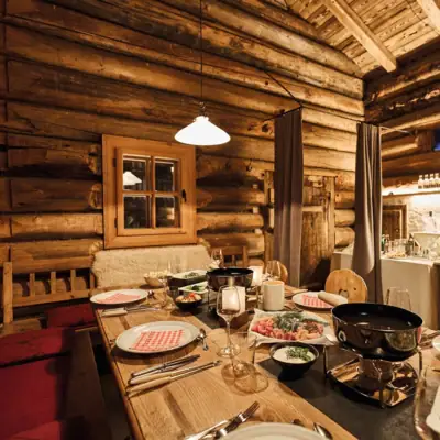 A table with food in a log cabin.