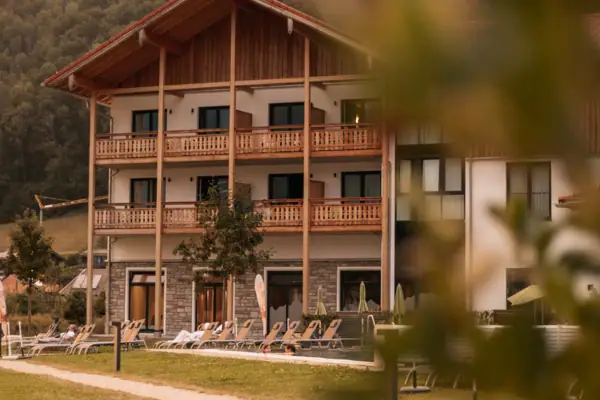 A building with a lawn and chairs in front of it.