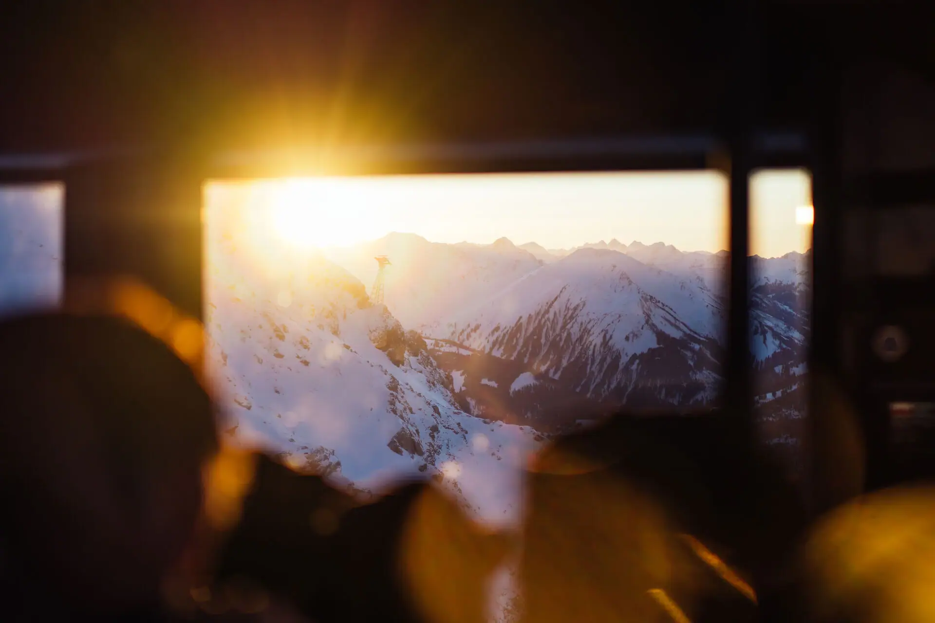 Sun shining through a window in a mountain landscape