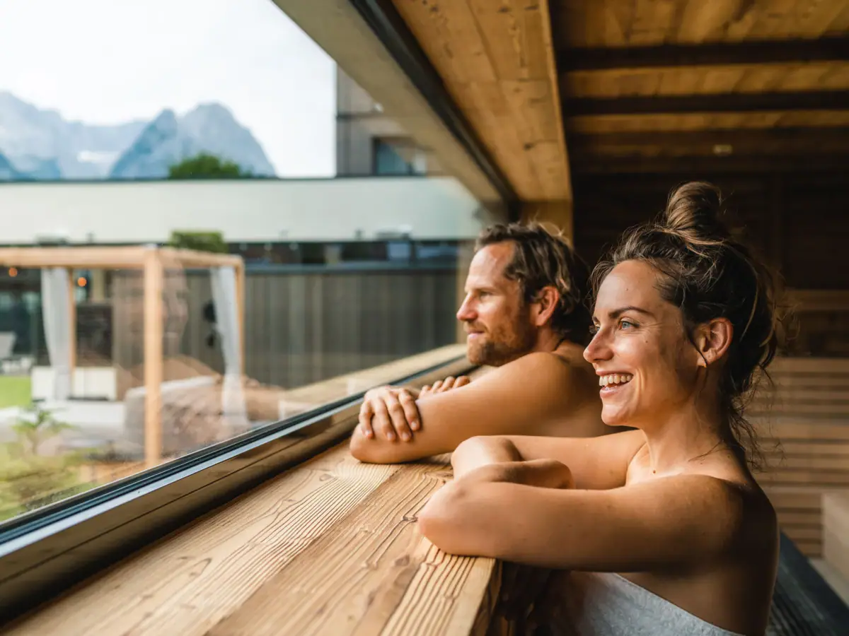 Panoramic sauna A man and a woman look out of a window.