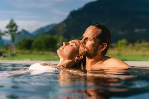 Outdoor pool aja Ruhpolding A man and a woman in the water.