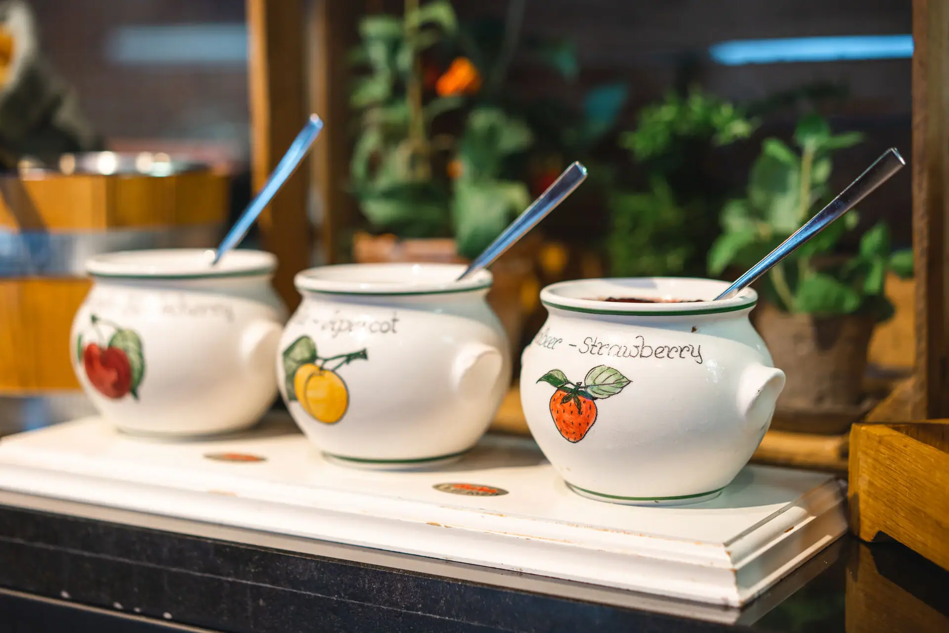 A group of white pots with spoons.