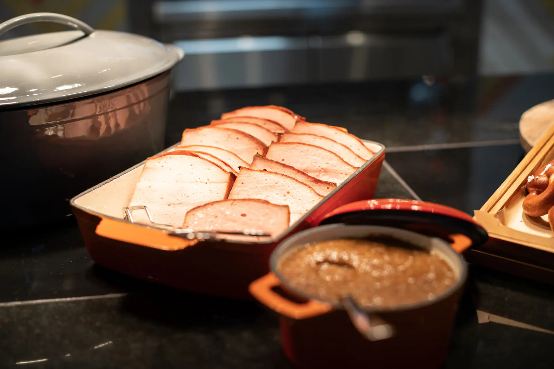 A tray with sliced meat and a bowl of soup.