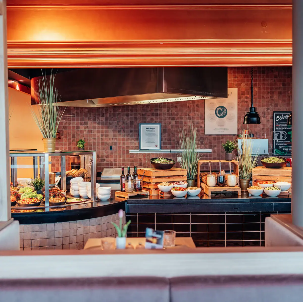 Food buffet in a restaurant with various dishes displayed.