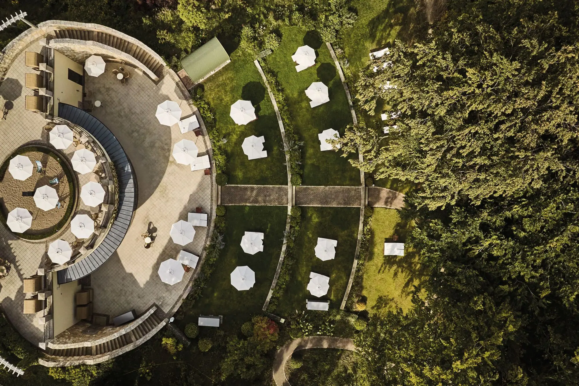 Aerial view of a building with sunshades and grass areas