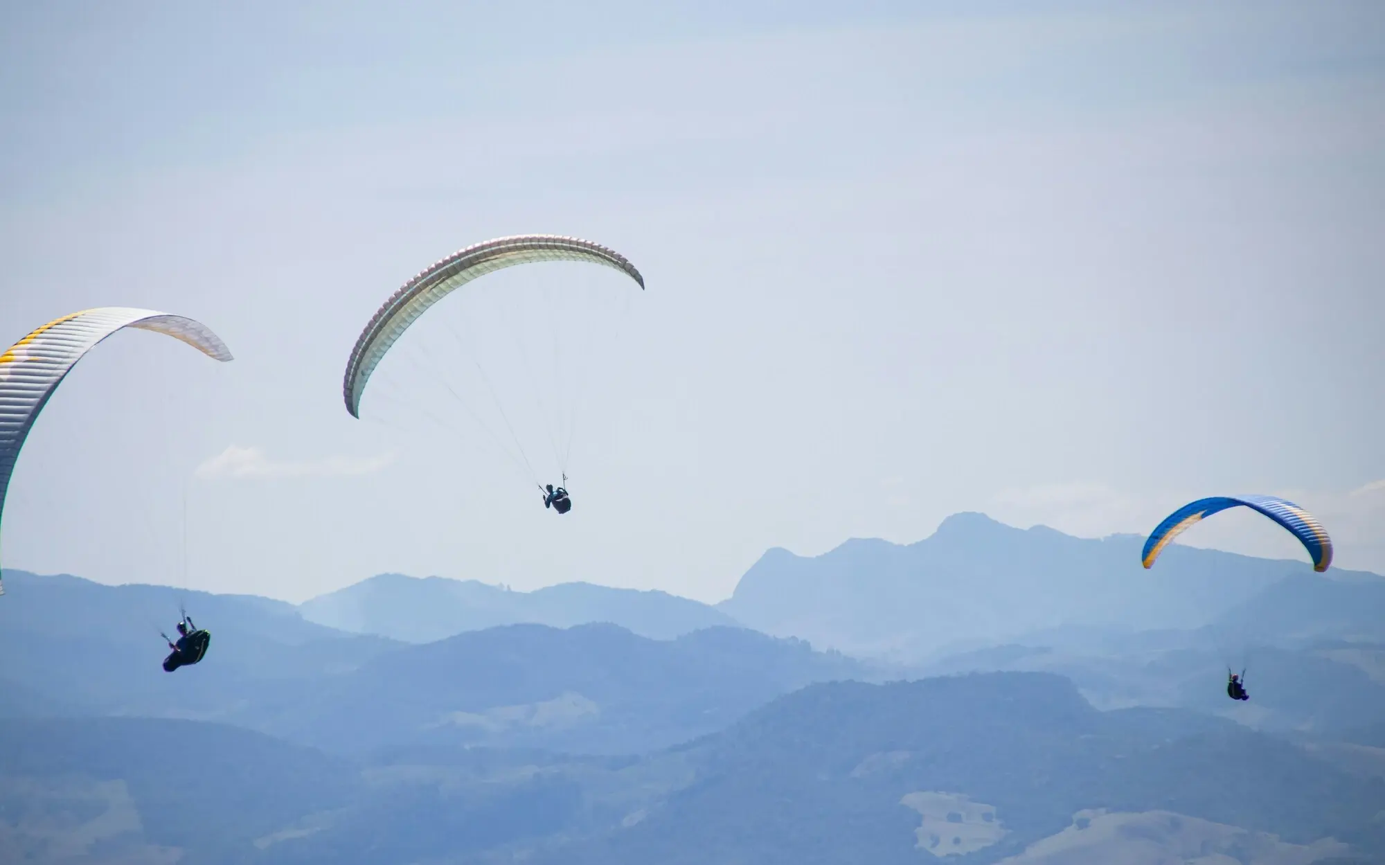 Group of people paragliding in the sky.