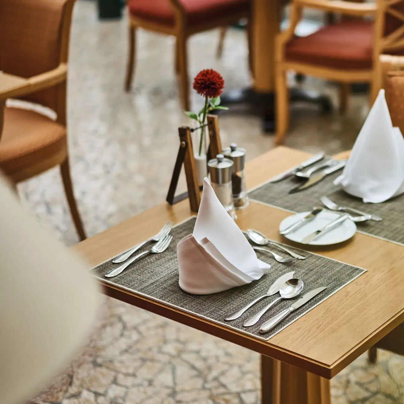 A table with napkins and cutlery.