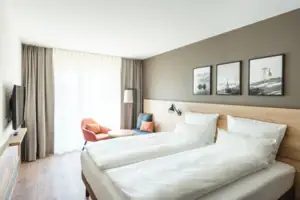 Double room A room with two beds and a chair.