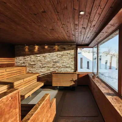 A sauna with wooden benches and windows.