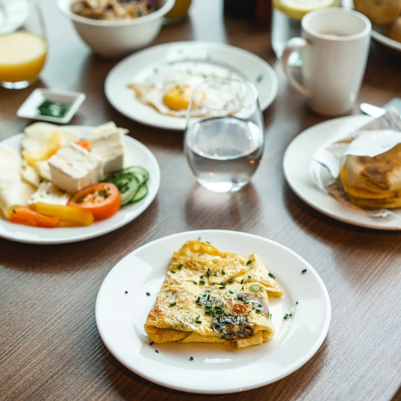 Breakfast A table with plates full of food and drinks.
