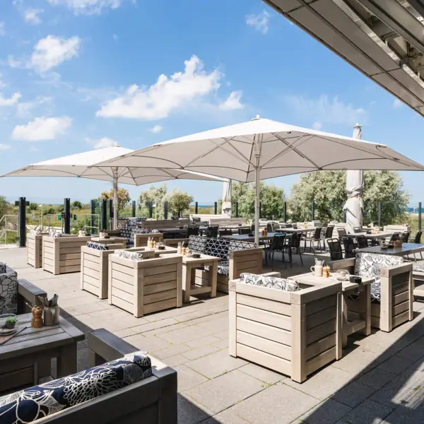 A terrace with tables and chairs.