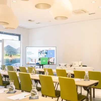 Meeting room A room with tables and chairs, featuring indoor furniture and a whiteboard.