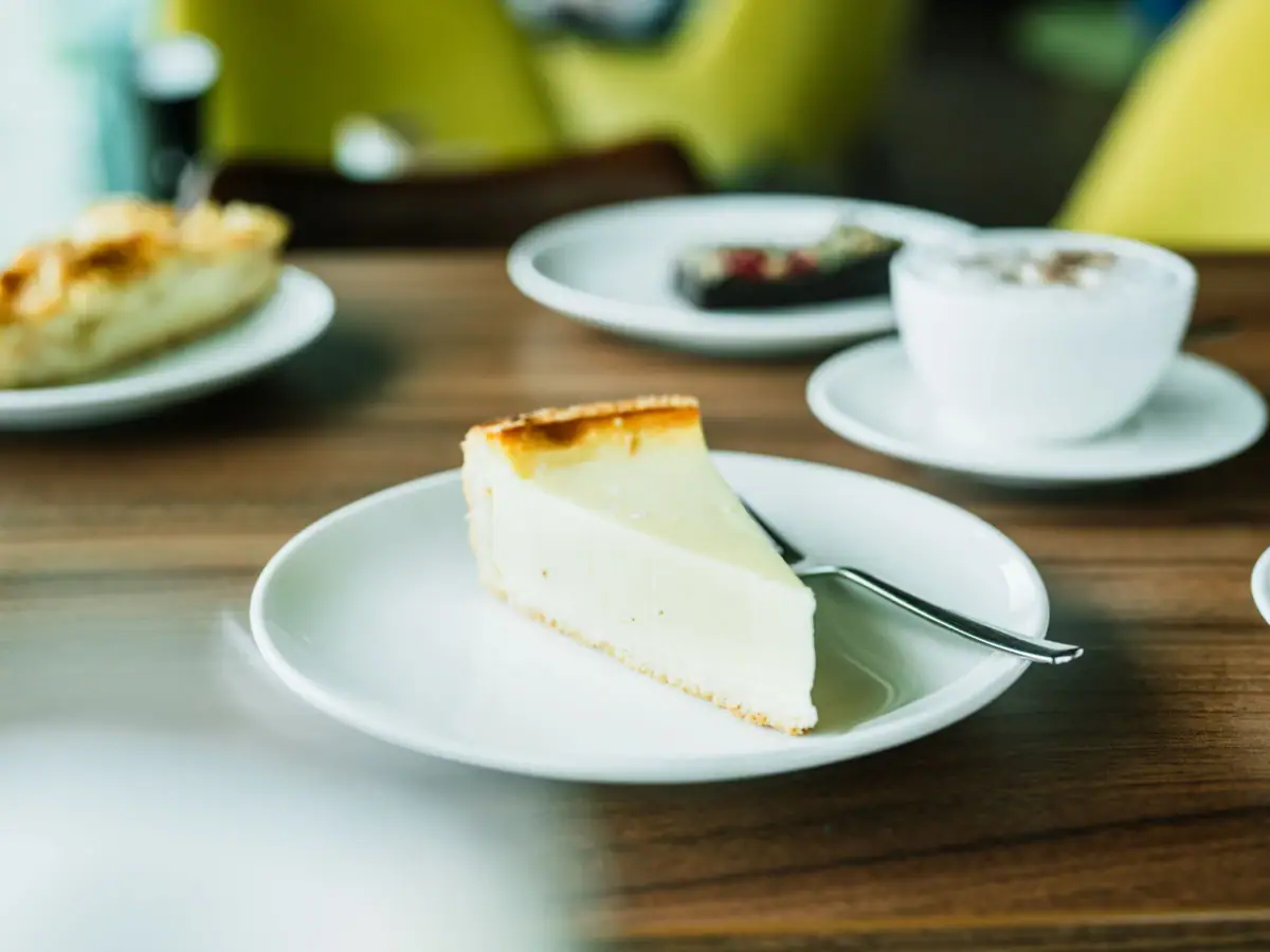 A piece of cheesecake on a plate with a spoon.