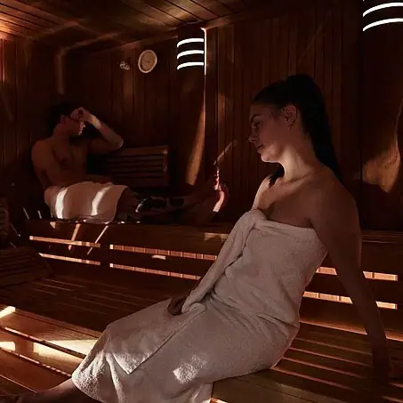A woman and a man in a sauna.