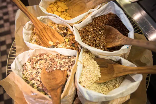 A group of cereal bags and wooden spoons.
