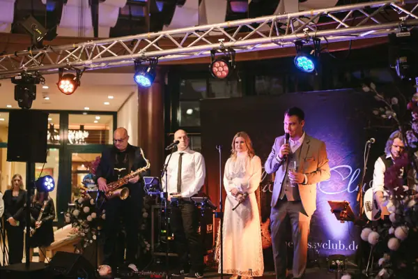 Live music A group of people on a stage at a concert with musical instruments.