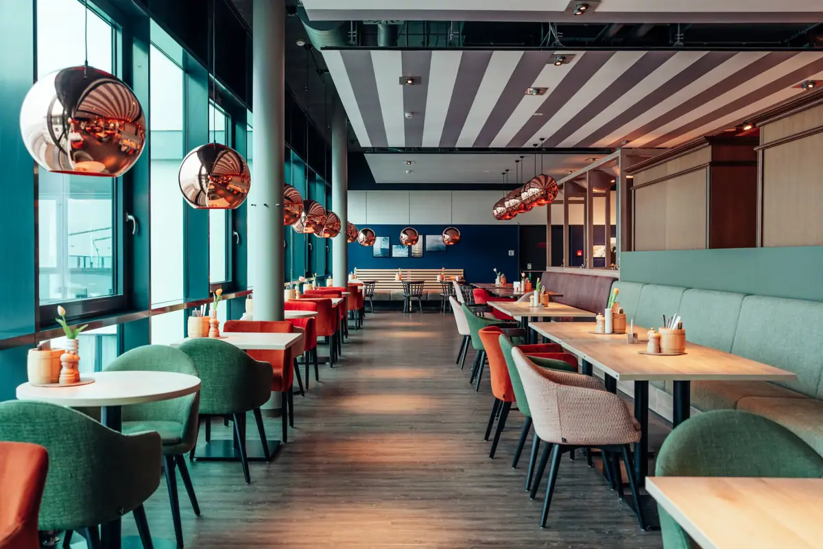 A restaurant interior with neatly arranged tables and chairs.