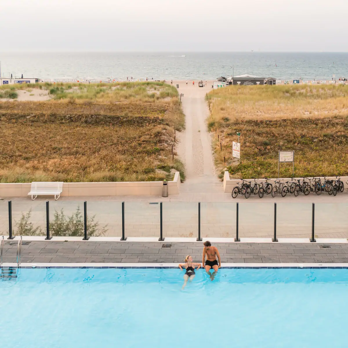 A man and a woman in the pool.