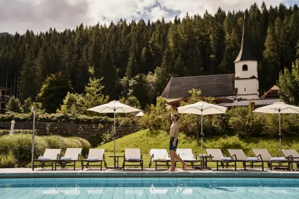 Outdoor pool A man walks past a pool.