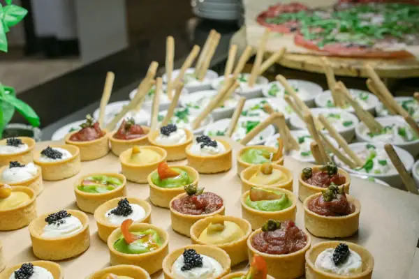A table full of snacks, pastries and desserts.