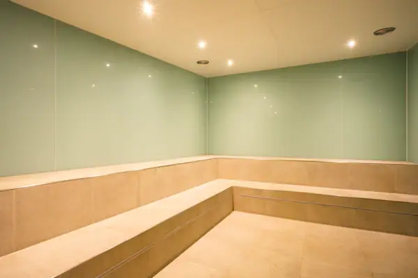 A room with a bench and light fittings.