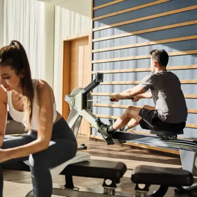 A man and a woman work out at the gym.
