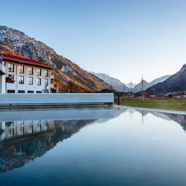 A pool with a building in the background.