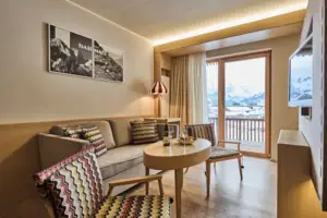 Sitting area A living room with couch, table and chairs.