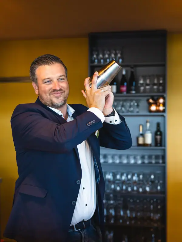 A man holds a shaker.