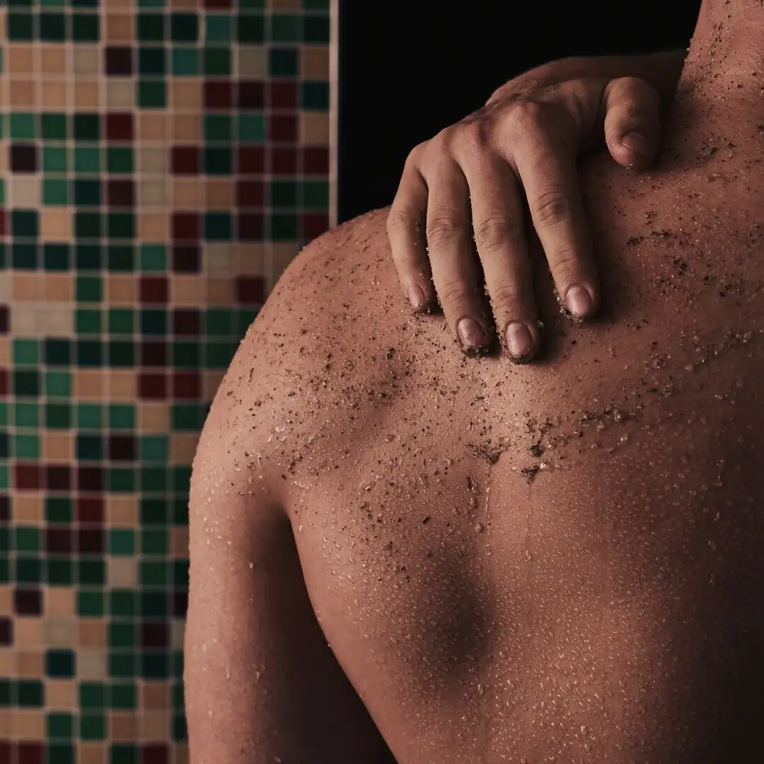 SPA scrub A man with a hand on his shoulder.