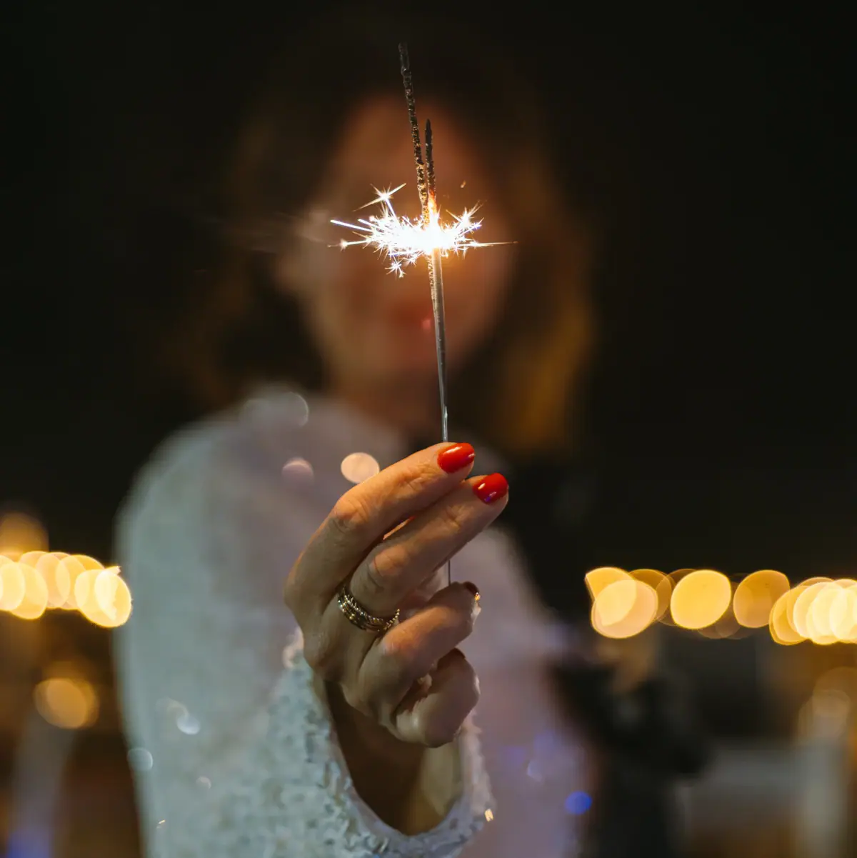One person holds a sparkler.