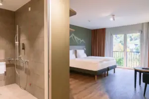 A room with a bed and a shower.