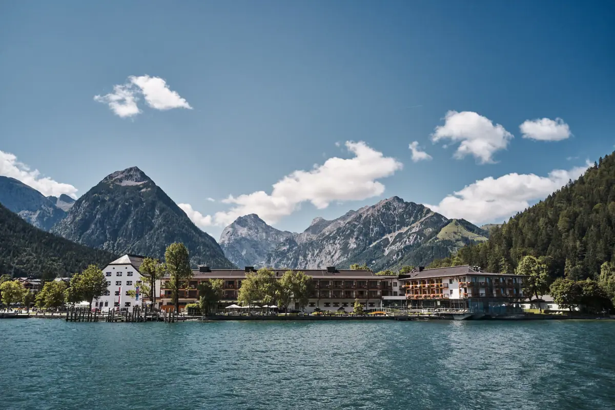 A building next to a body of water under a cloudy sky.