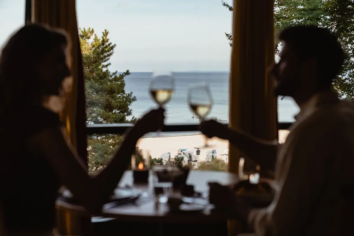 Restaurant view A couple holding wine glasses at a table.