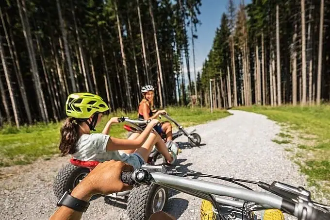 Group of people mountain karting on a gravel road.