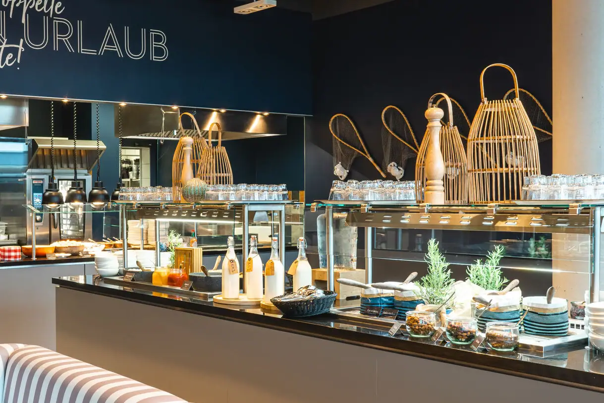 Buffet stations with cereal bowls and milk bottles.