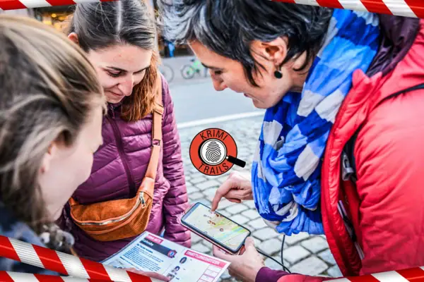 A group of women are looking at a mobile phone.