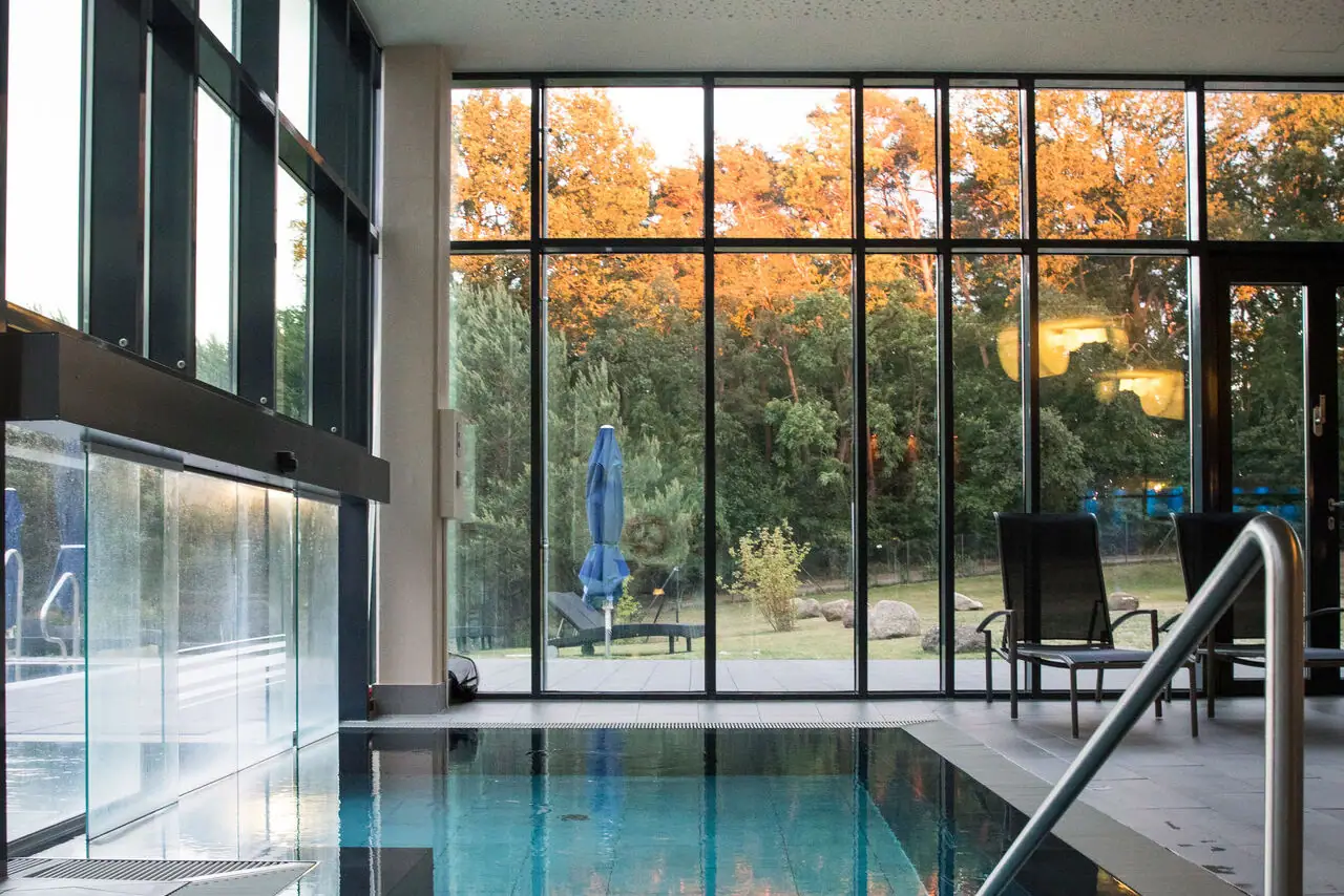 Sunrise or Sunset SPA  An indoor pool with a large glass wall and large window.